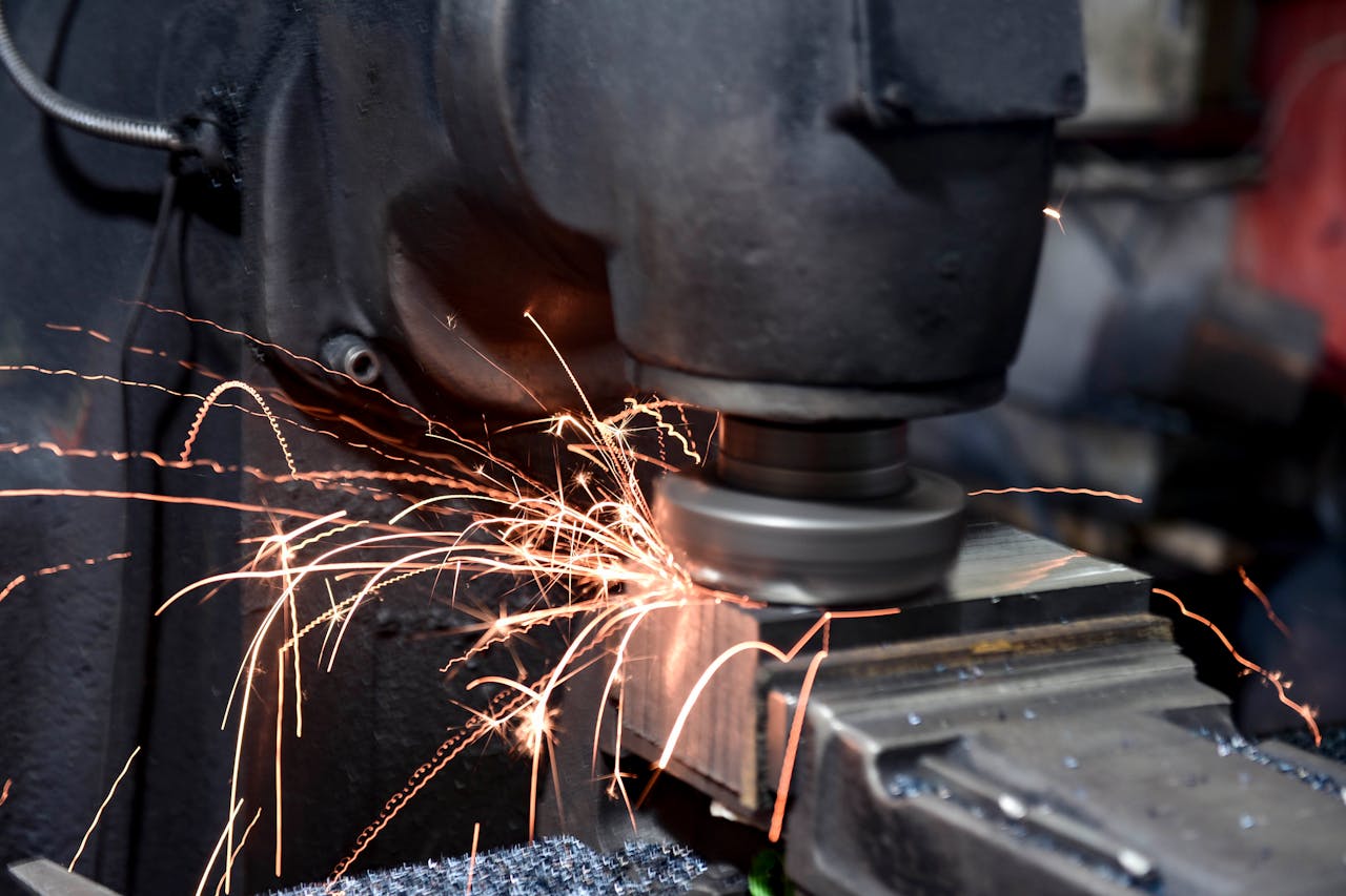 ours-journey Close-up of a grinding machine in action with sparks flying in an industrial setting.
